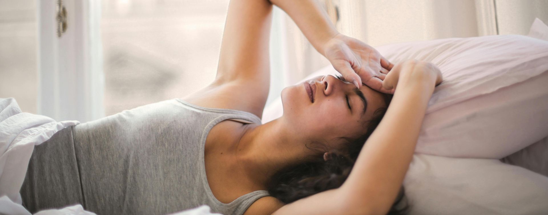Woman resting on bed looking relaxed and comfortable becasue she has The Pop In Concierge Service - St Paul.